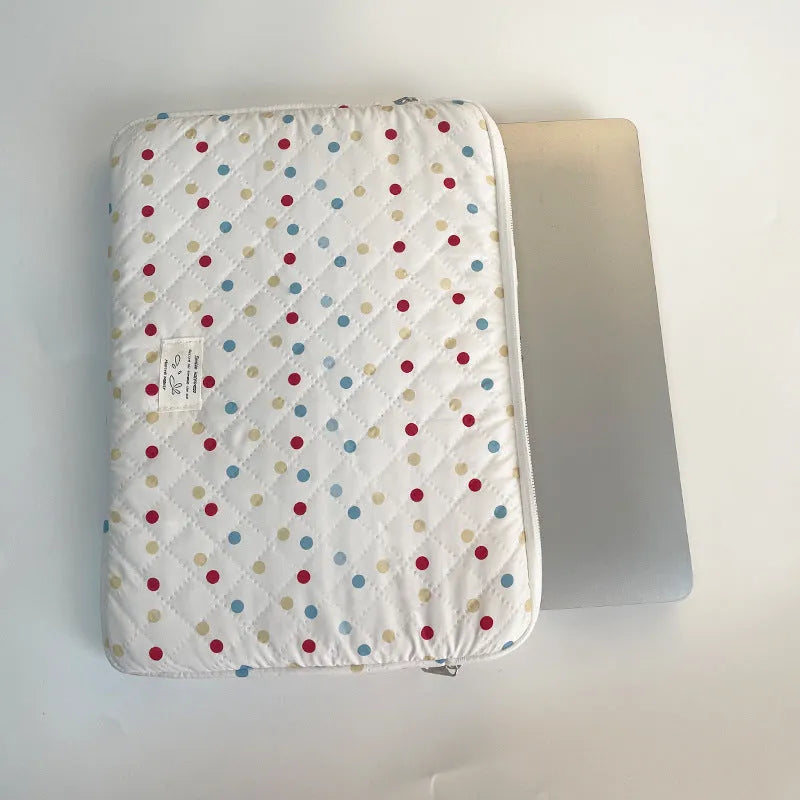 Women's polka dot polyester laptop bag showing front view with storage compartments