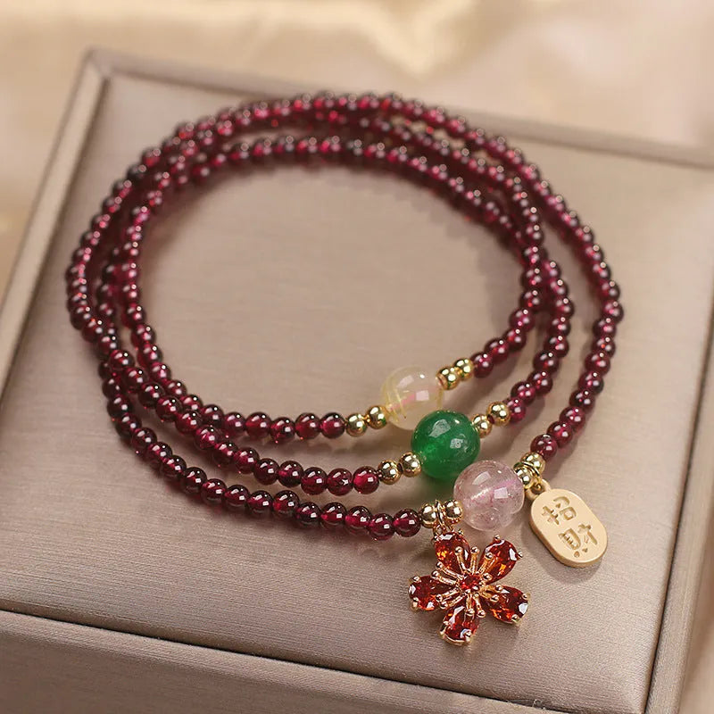 Women's crystal pomegranate bracelet with red cherry blossom beads and sequin detailing