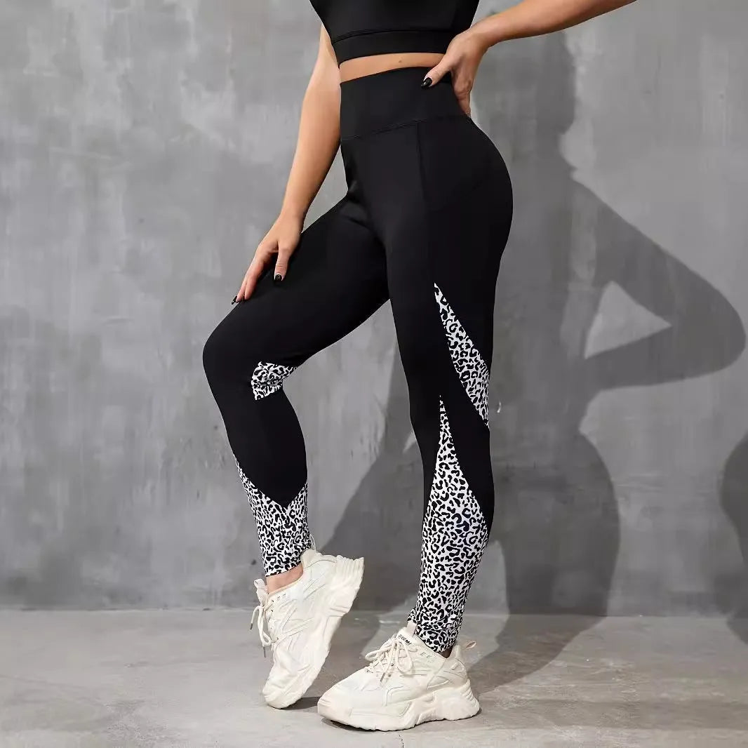 Women's black high waist yoga leggings with contrast patchwork leopard print design and side pocket