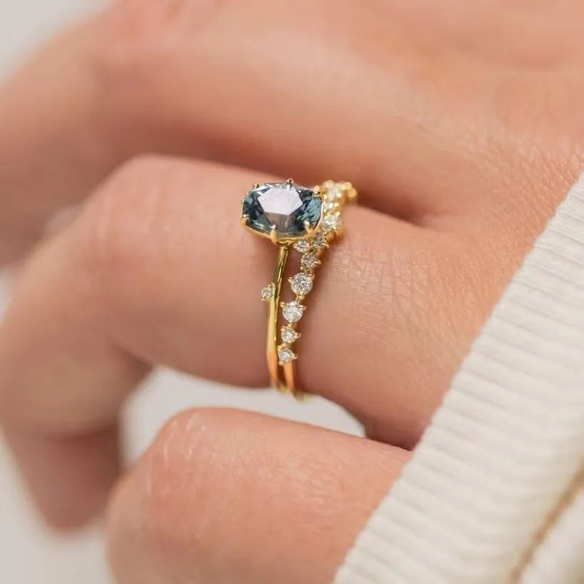 Gold plated floral shaped women's ring with green zircon stone details on alloy band