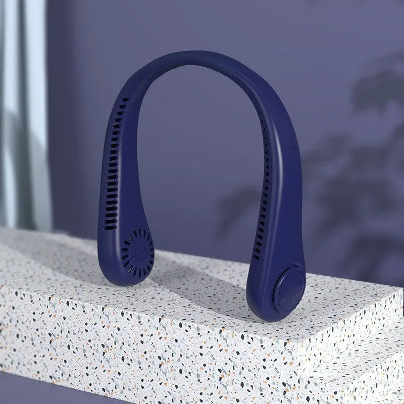 A pink bladeless neck fan hanging around a person's neck, showing its compact design and air outlets.