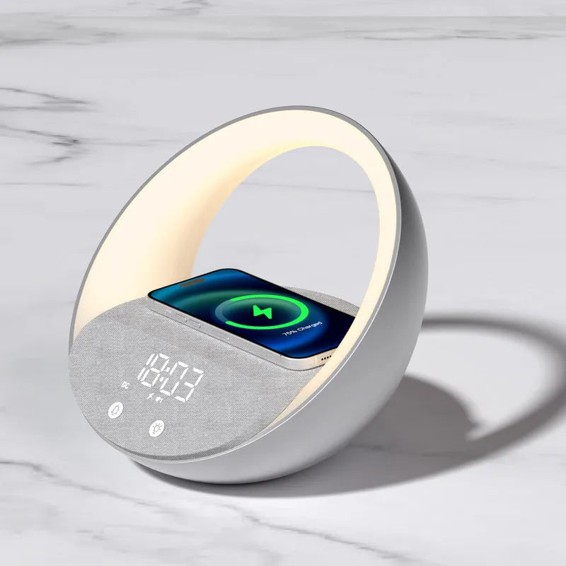 Beige multifunctional wireless charging clock with Bluetooth speaker and warm white LED wake-up light on a wooden table.