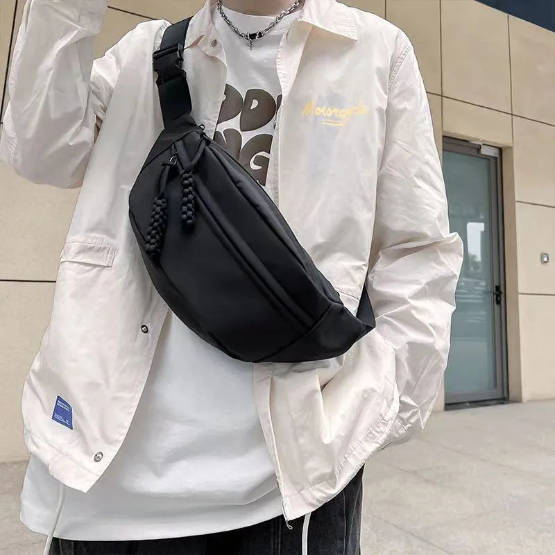 Small men's polyester crossbody chest bag in black with nylon lining and 35cm width