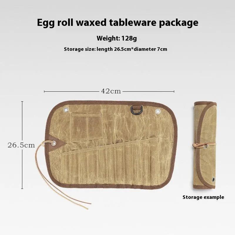 Green waxed canvas tableware storage bag containing wooden handle knives, forks, spoons, and chopsticks for outdoor use.