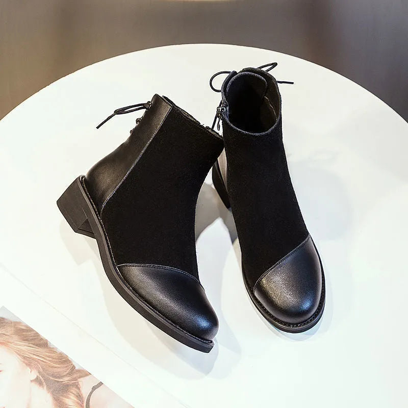 Black women's knee-high Martin boots with side zipper, round toe, and decorative bow.