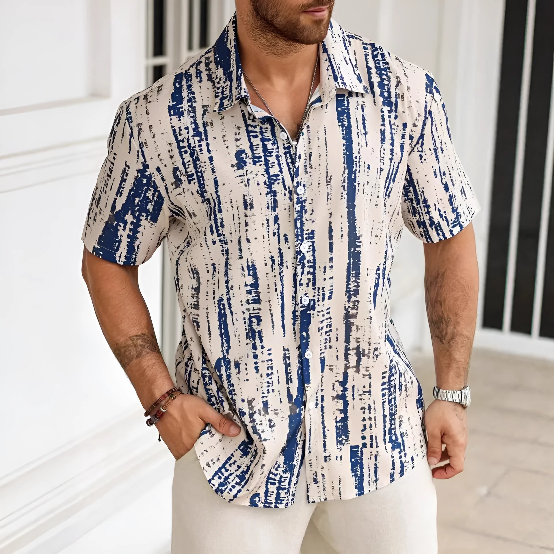 Man wearing a short sleeve casual shirt with 3D printed stripes in a choice of apricot, blue, white, or yellow.