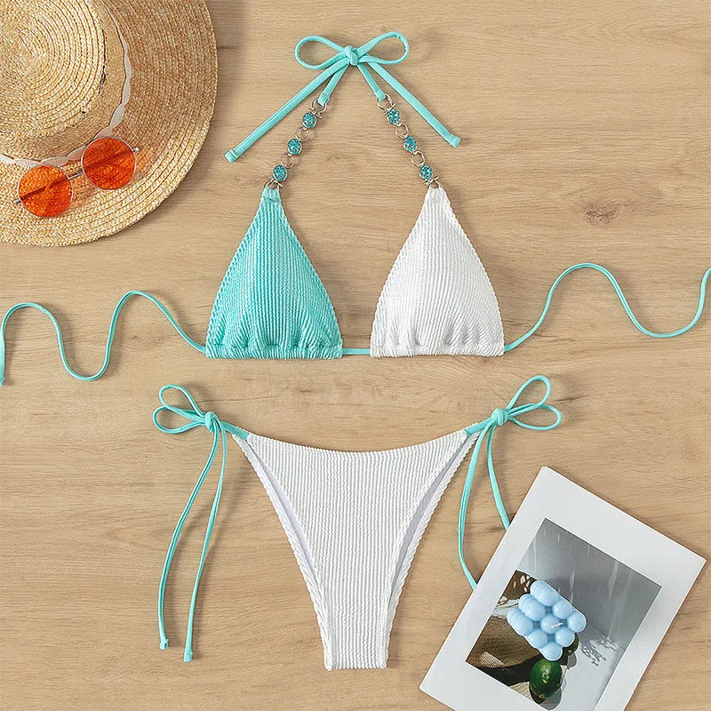 Women's colour-matching bikini set with lace-up front and pearl chain detail on a sleeveless top.