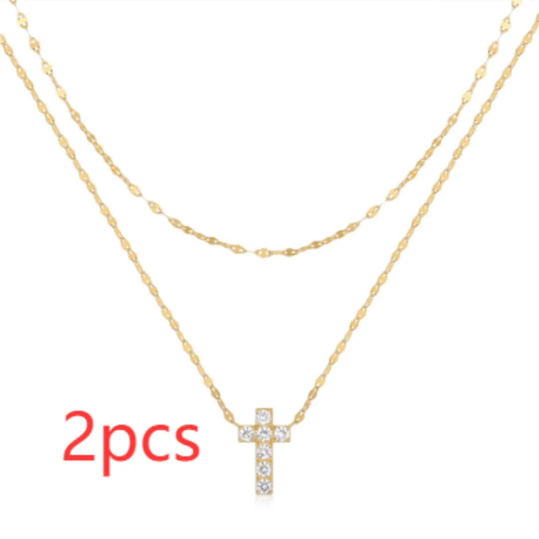 Sterling silver double layer cross pendant necklace with a clavicle chain in a gold tone finish.