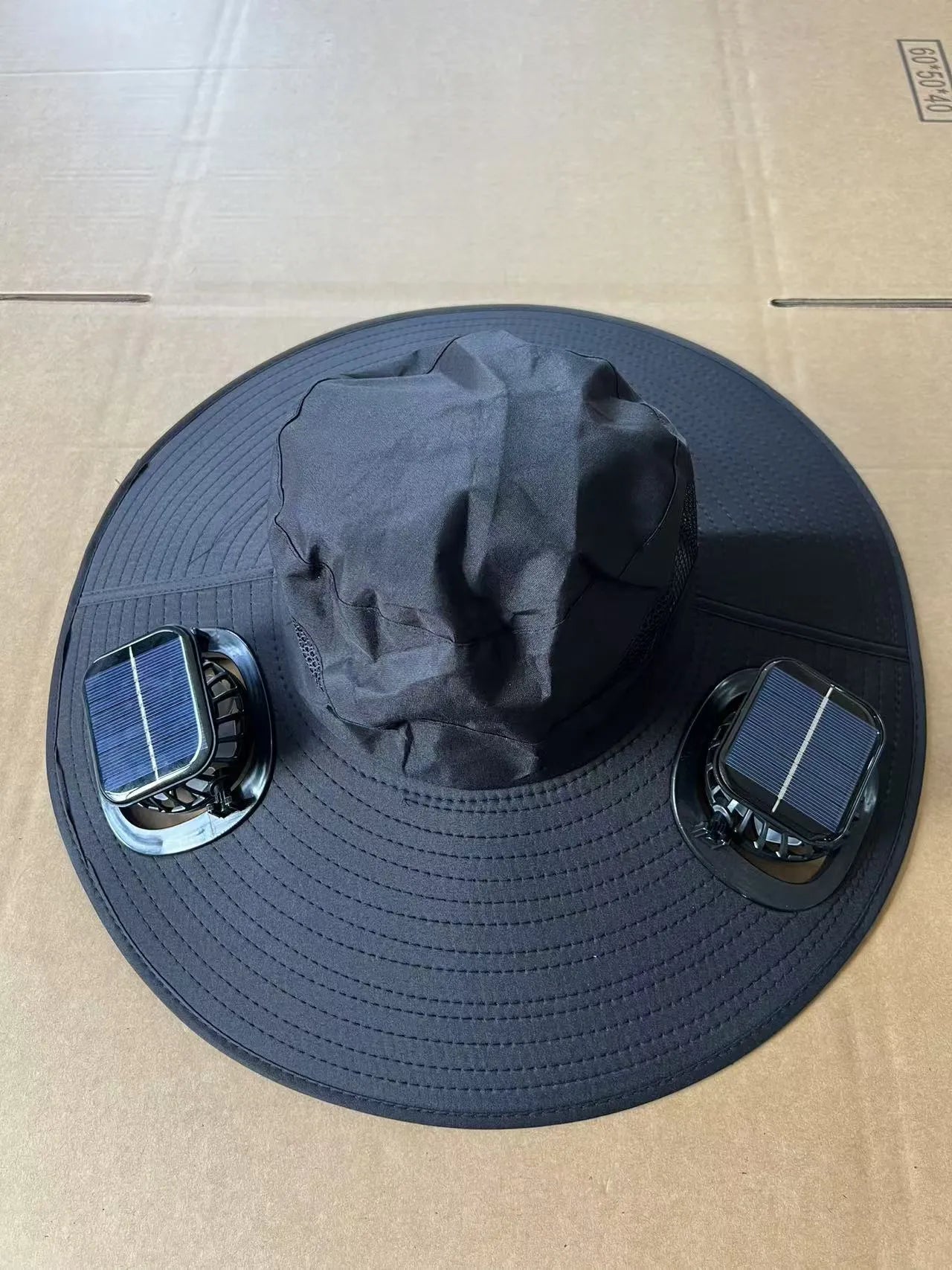 Men's grey solar cooling cap with large eave and visible fan unit on the front.