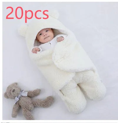 A baby quilted sleeping bag wrapper in a plain colour, showing its quilted pattern and soft cotton blend fabric.