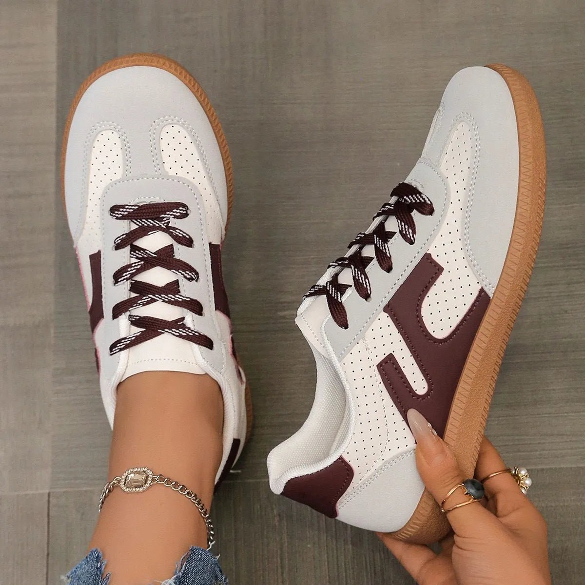 A pair of retro-style low-top lace-up sneakers in a selected colour on a plain background.