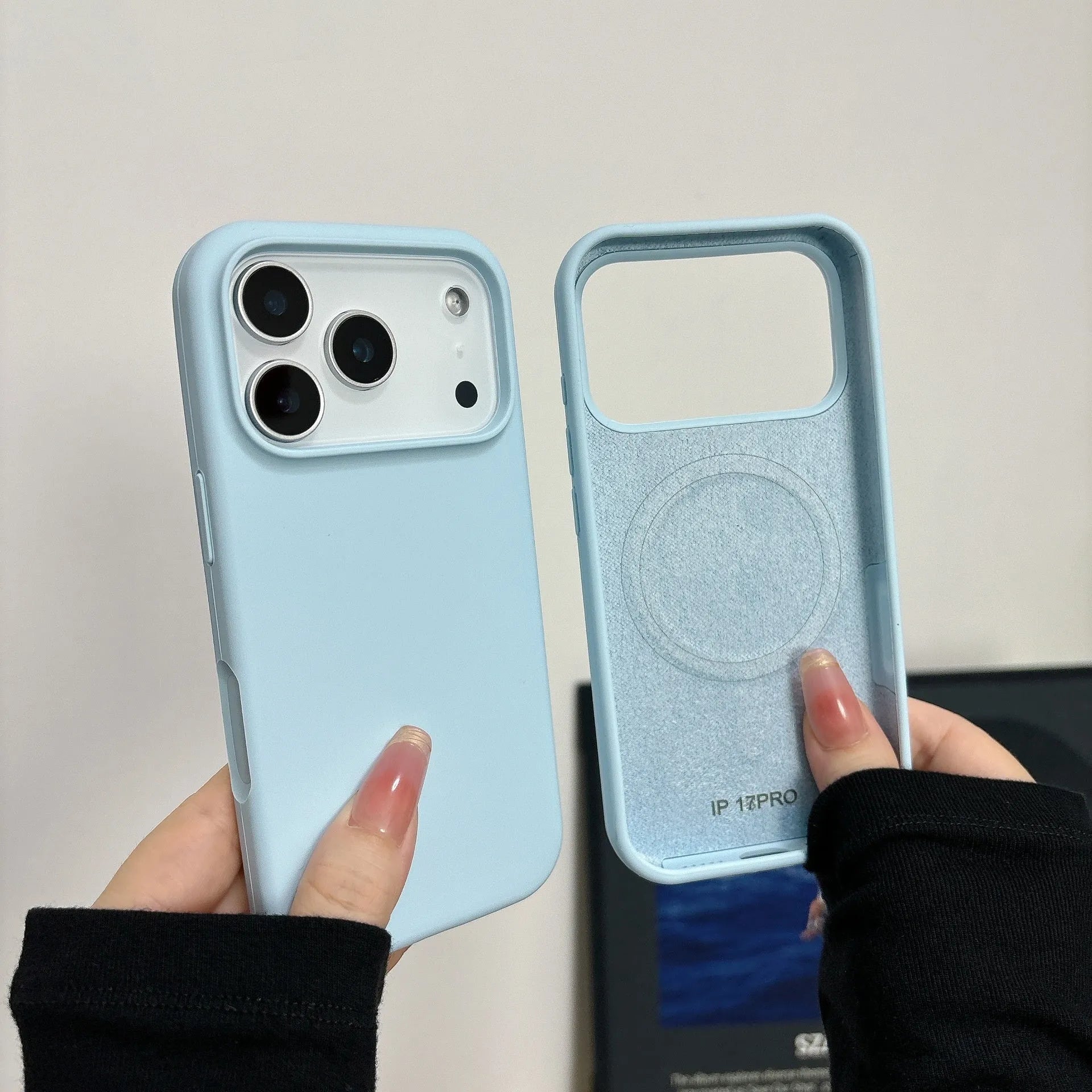 Liquid silicone magnetic iPhone case with Ai button in antique white colour on a table.