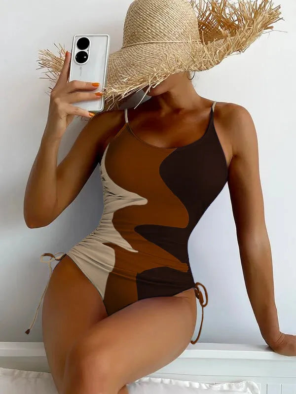 Women's blue sleeveless backless one-piece swimsuit with striped pattern on a mannequin