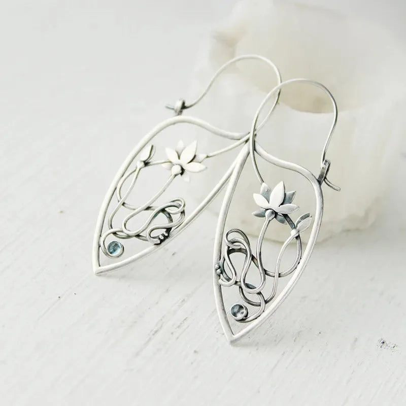 Silver women's earrings with lotus vine design featuring geometric floral patterns and circular rhinestones