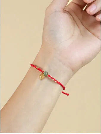 Handmade women's bracelet woven from 925 silver and red Hetian jade with carrying strap.