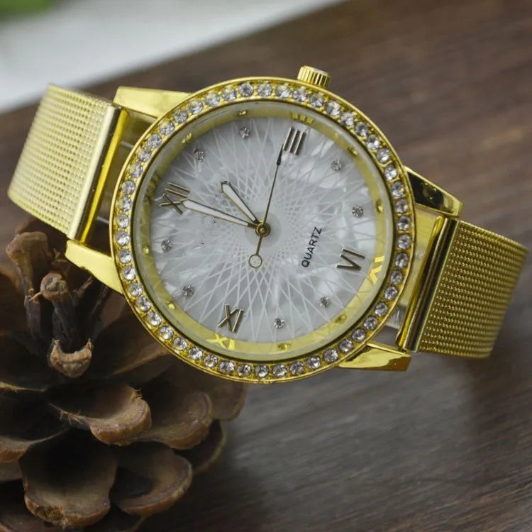 Golden mesh strap alloy electronic watch with round dial and world time GMT functions on a plain background