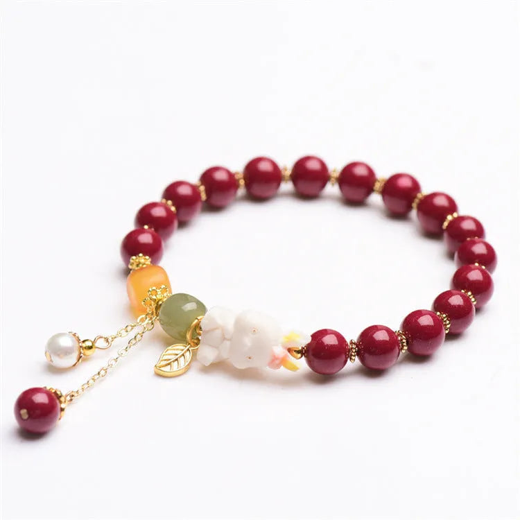 Tian Yu natural cinnabar bracelet with rabbit motif in purple gold sand colour