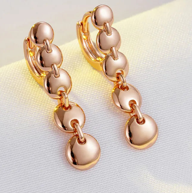 Long round gold retro earrings with woven copper texture, shown as a pair.