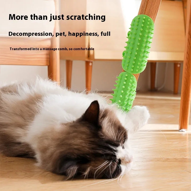 Black silicone cat grooming brush with comb teeth and an adjustable mounting strap.