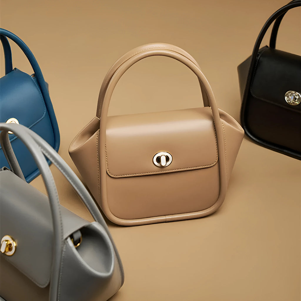 Wing shape cow leather cross-body handbag with buckle detail and fabric lining