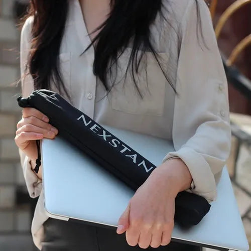 Sagacious black foldable laptop stand with enhanced nylon construction on desk