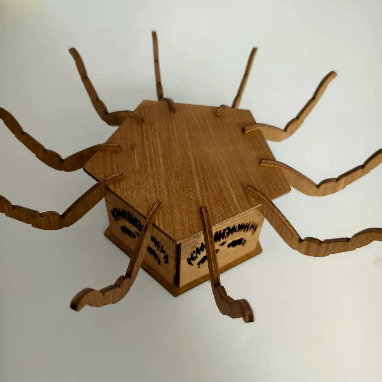 Wooden spider-shaped mini lantern candlestick Halloween decoration on a table