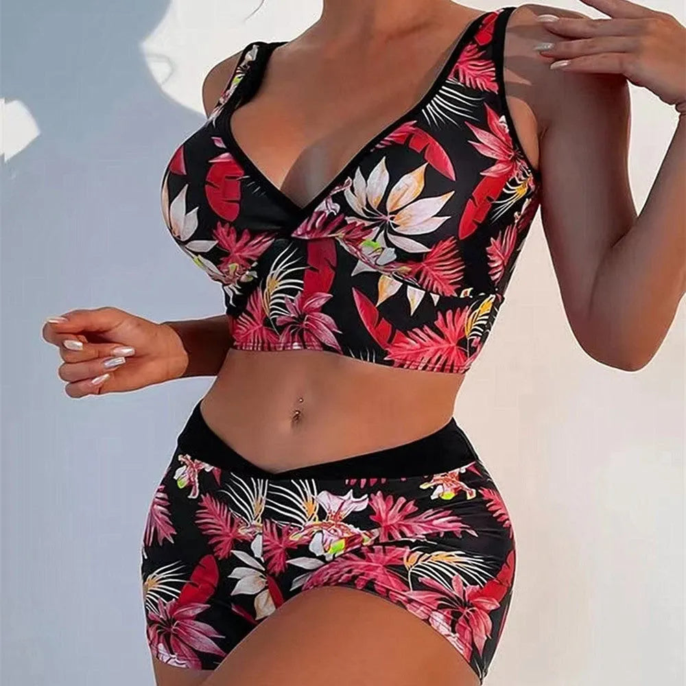 Women's two-piece printed boxer swimsuit set in a multi-colour pattern, showing sleeveless top and briefs.