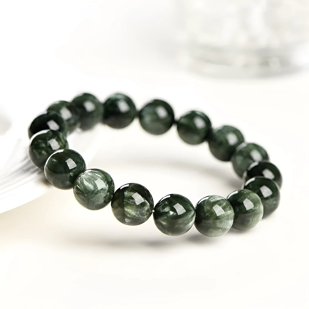 Green Dragon Crystal round bead bracelet with Ruyi design elements on a wrist.