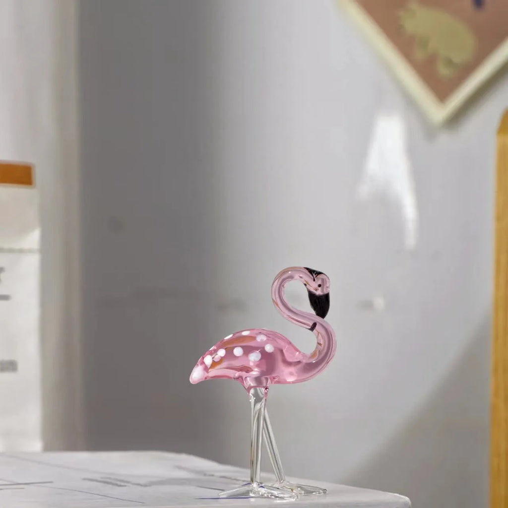 Pink and white crystal flamingo decorative ornament on a table, showing modern simple style.
