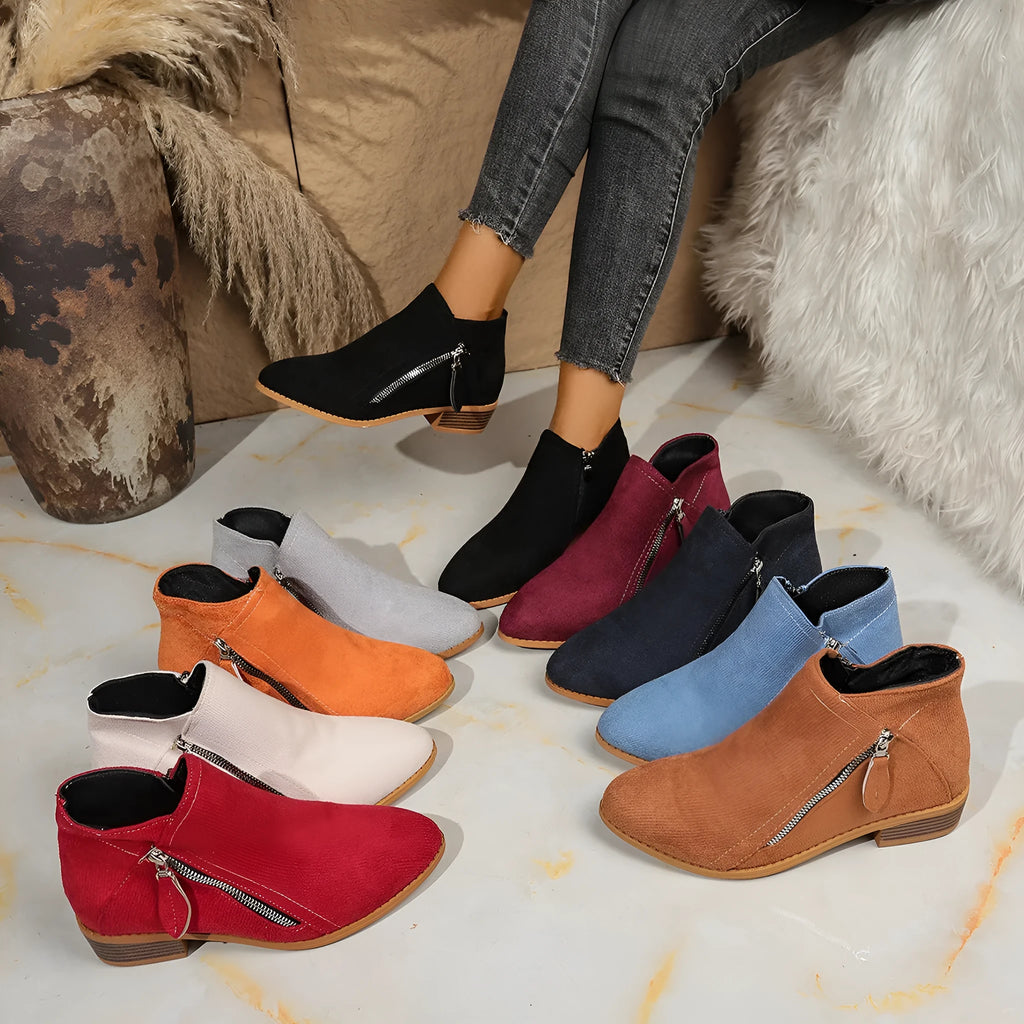 Suede women's ankle boots with side zipper in beige, shown on a white background