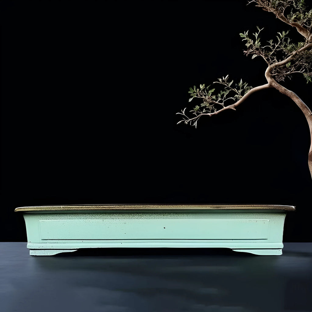 Handmade retro purple sand glaze ceramic bonsai flower pot in green colour on desktop