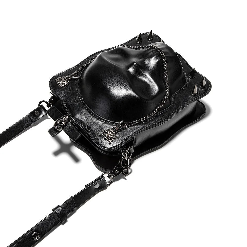 Black gothic crossbody bag with skull design, stitching, rivets, and chain details.