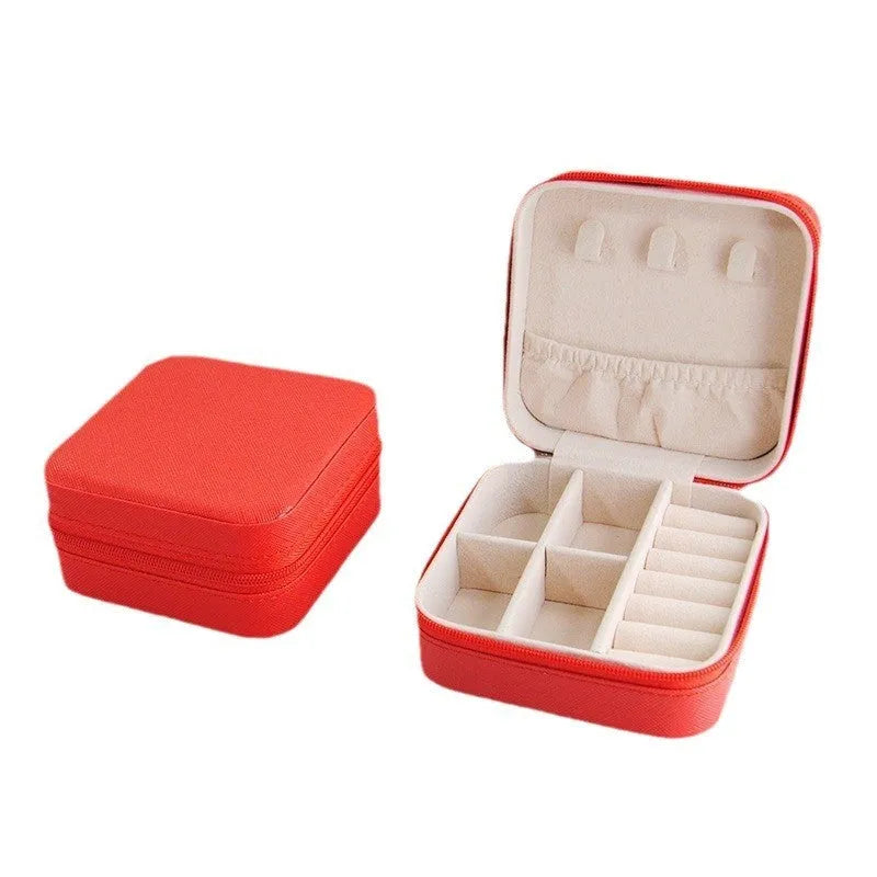 Small leather jewellery box in cross pattern, 10cm size, for earrings and rings, on a flat surface.