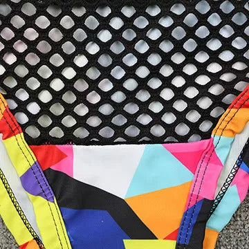 Women's multicolour checkered bikini set with cross-strap bra and high-waist fishnet briefs on a neutral background.