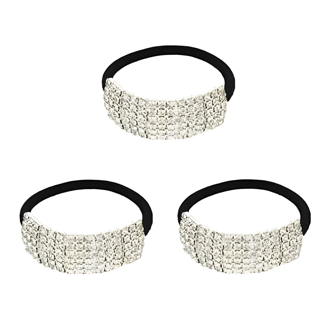 Three silver hair rings with rhinestone crystals on a light background