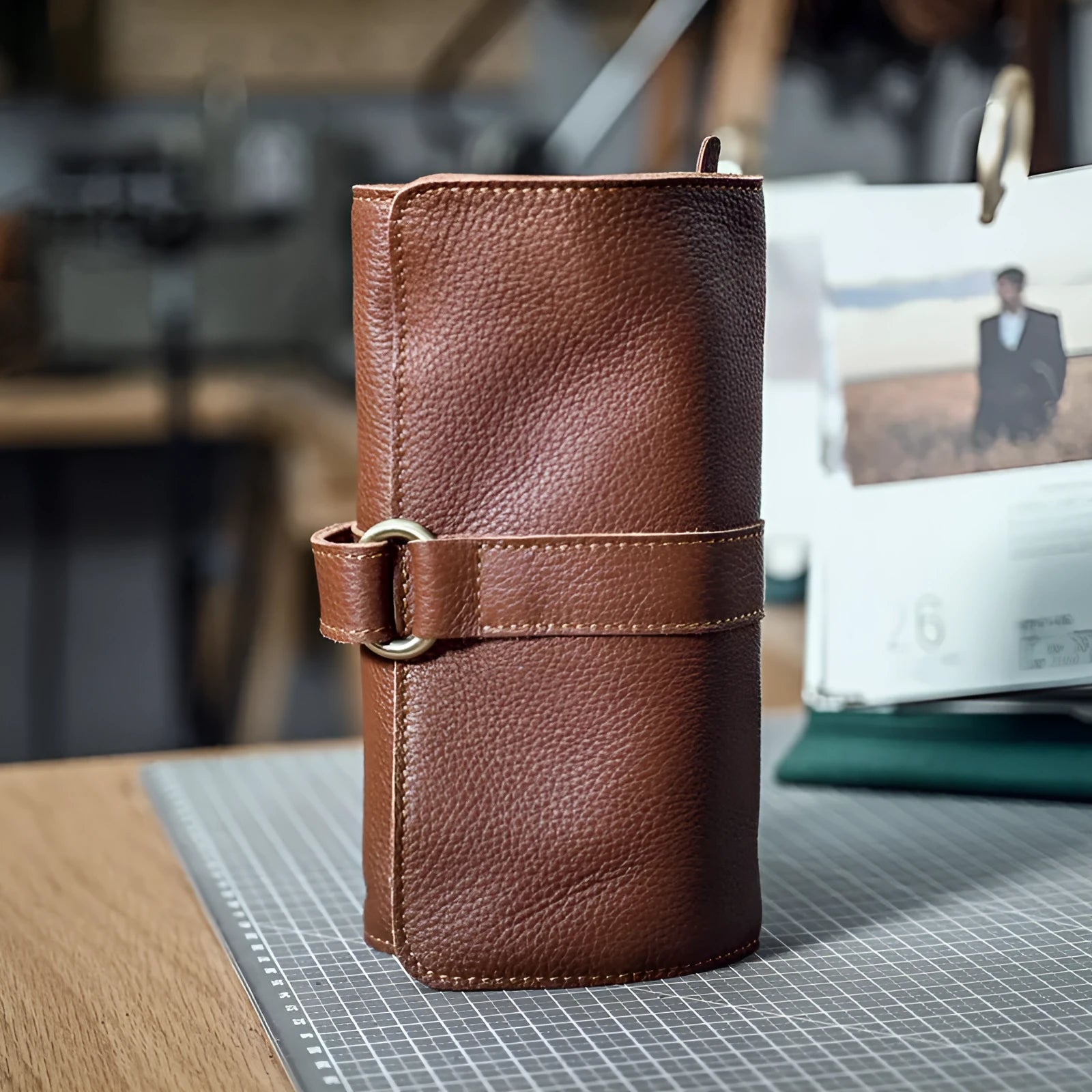Handmade dark brown cow leather vintage bifold wallet with tape extraction closure, shown open.