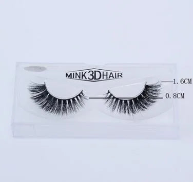 Pair of faux mink eyelashes with long tail and cotton stem against white background