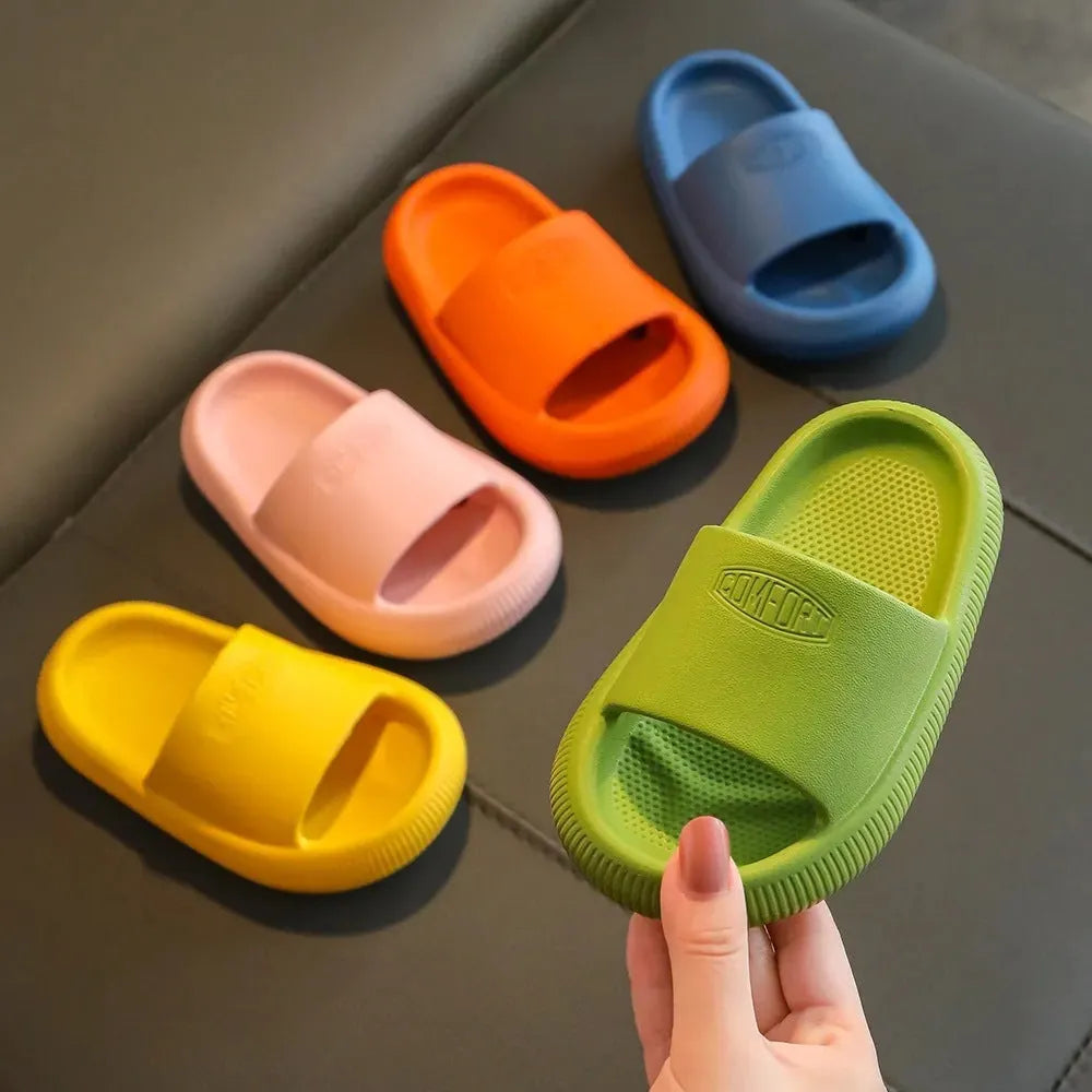 Colourful children's EVA slippers with a textured non-slip sole, shown in blue, green, orange, pink and yellow.