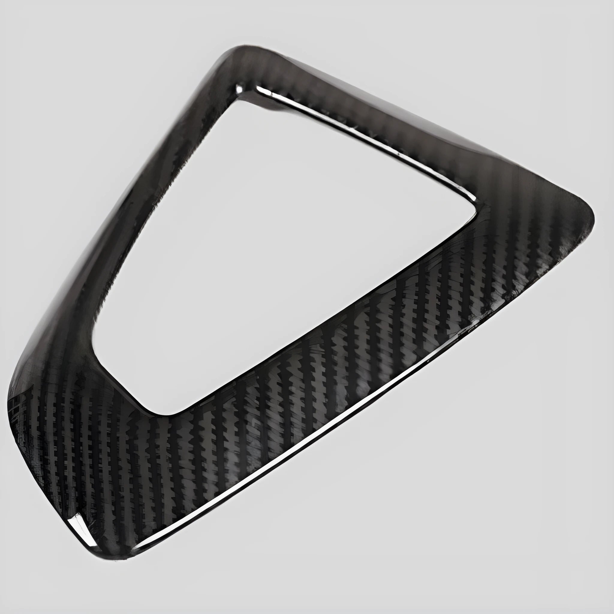 BMW gear selector base frame in carbon fibre pattern left titanium colour, showing 3M adhesive backing.