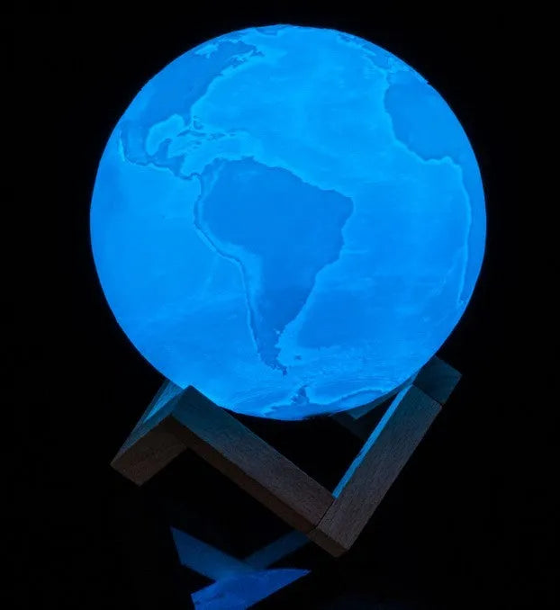 3D printed white moon lamp on wooden stand with touch-sensitive metal ring at base.