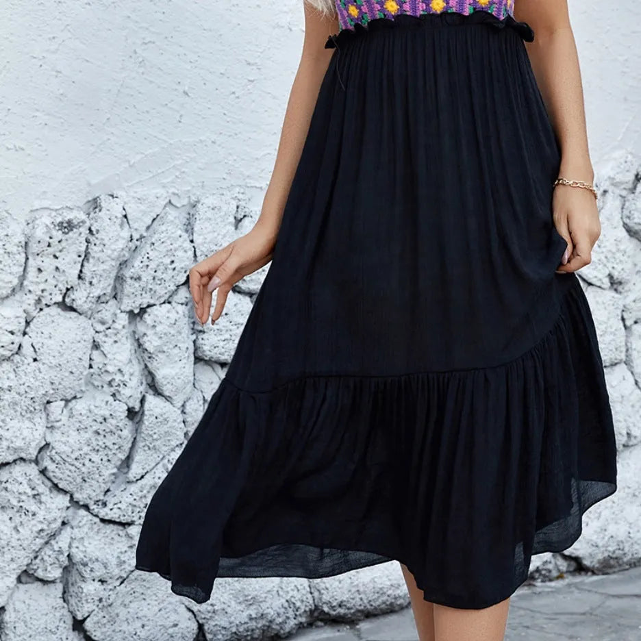 Purple sleeveless dress with hand-hooked white floral embroidery, shown on a hanger.
