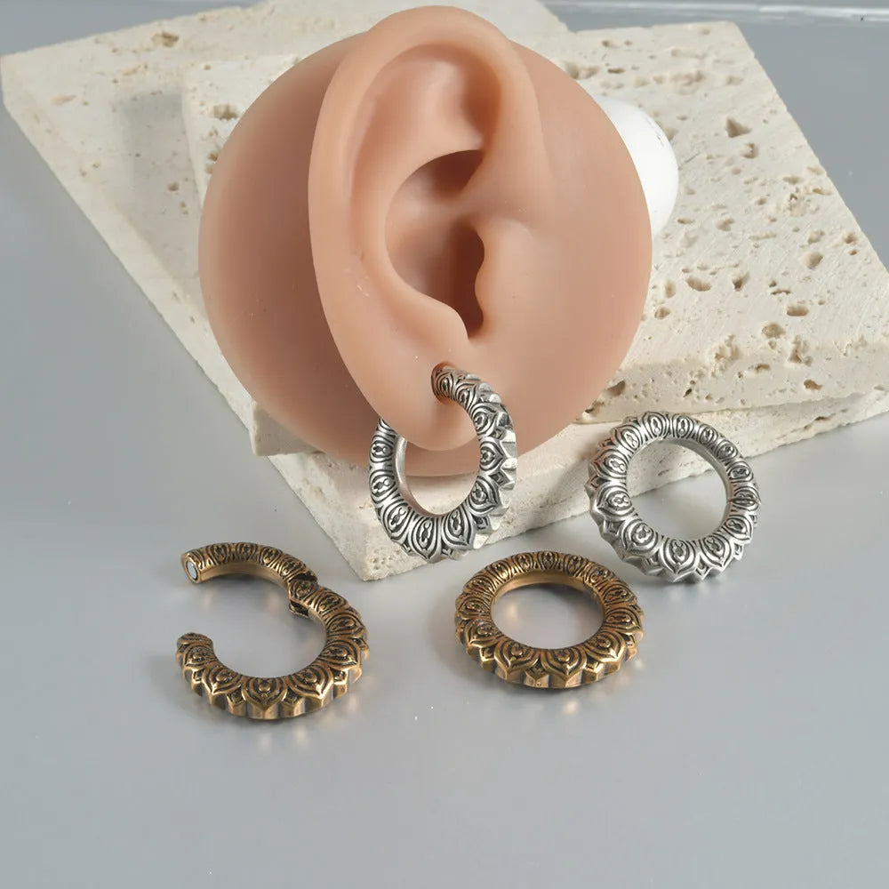 Large hollow out stainless steel earrings with an antique silver dragon design.