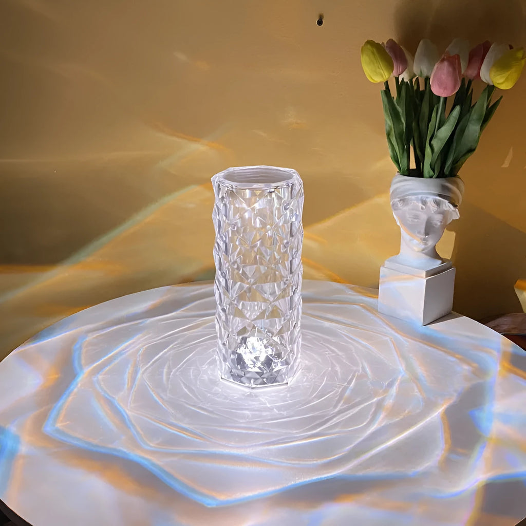 Modern acrylic rose LED table lamp with diamond base and touch control on wooden surface