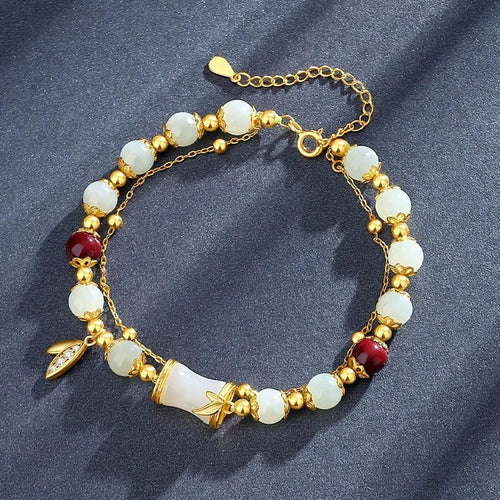 Retro style bamboo bracelet with coloured glass floral beads and ruyi design