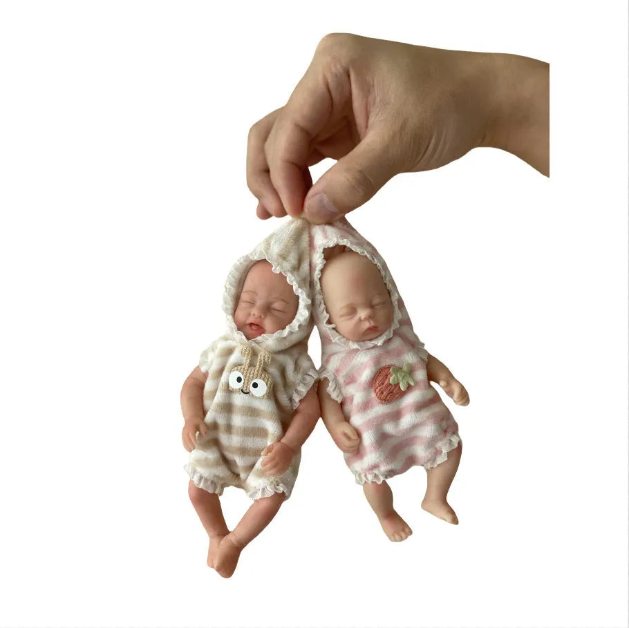 15cm solid silicone MINI palm doll simulation baby, bald girl version, on display