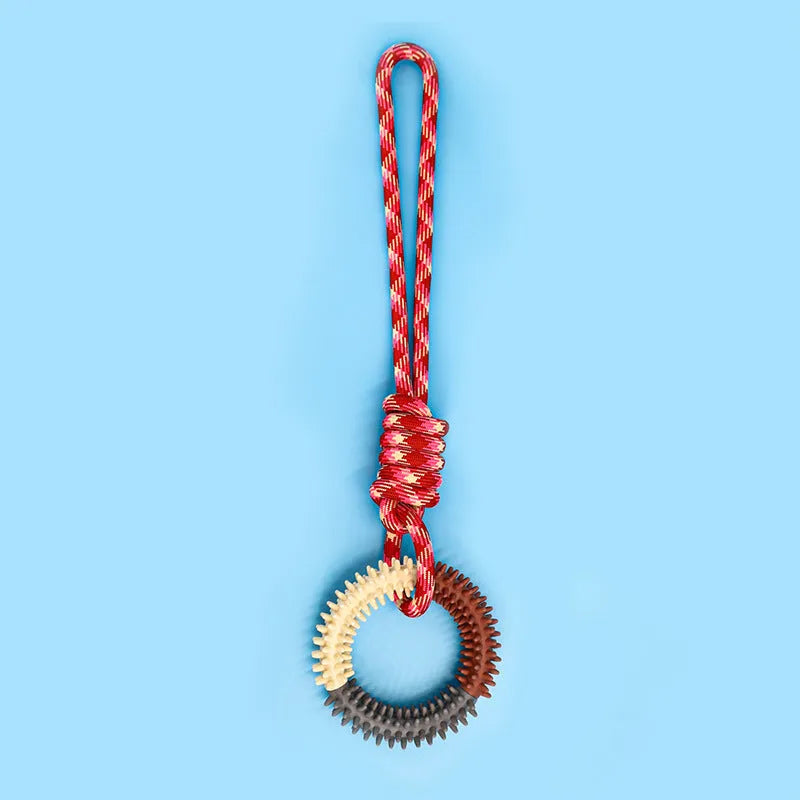 Blue braided rope dog toy with a knot, shown on a wooden floor.
