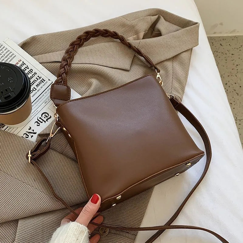 Retro woven PU leather bucket bag in khaki colour with crossbody strap.