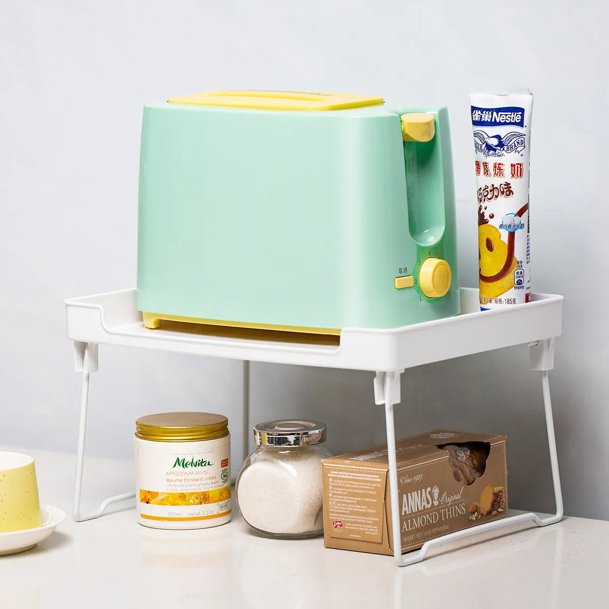 Plastic kitchen organisation rack with modular design for cupboard shelves and countertops