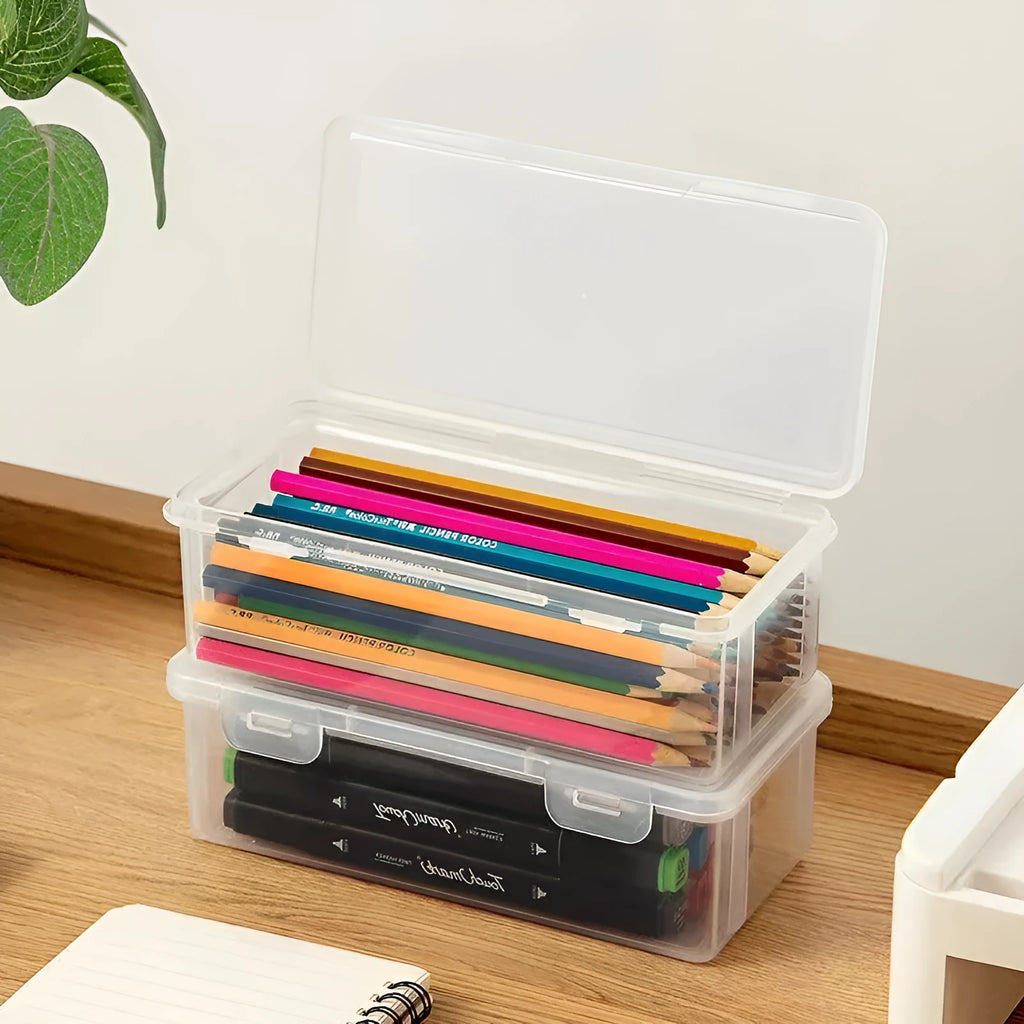 Large clear plastic stationery storage box filled with coloured pencils and crayons