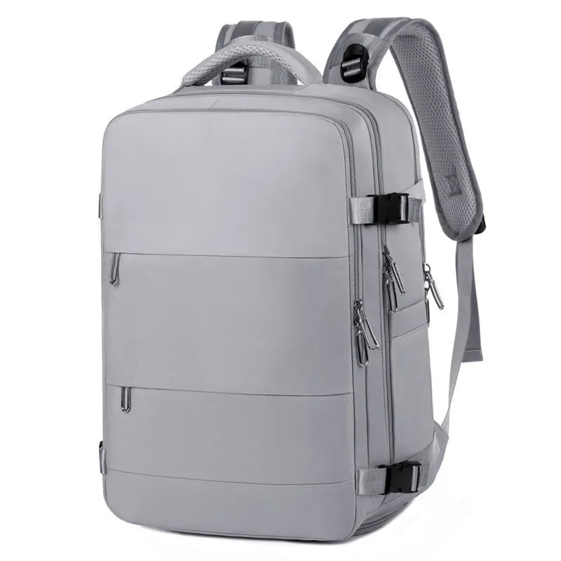 Large grey travel backpack for women with multiple compartments, shown open.